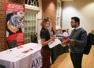 Student at a job fair speaking to a career advisor.