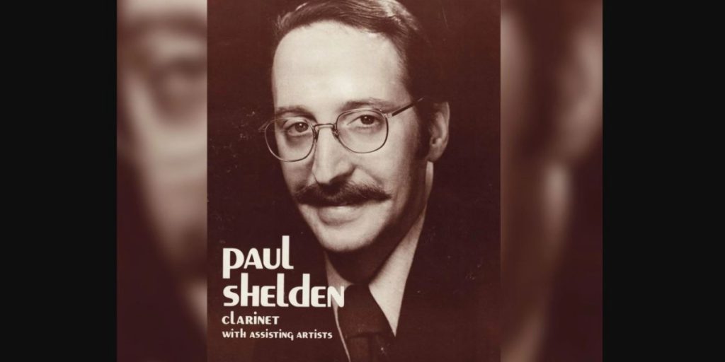 headshot of Dr. Paul Shelden with the words "Paul Shelden clarinet with assisting artists" on top in white